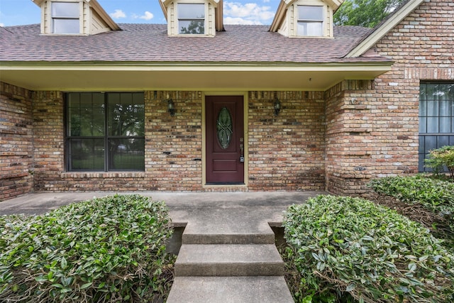 410 S Walnut Grove Rd, Midlothian, TX 76065 - view of exterior entry featuring a porch, brick siding, and a shingled roof