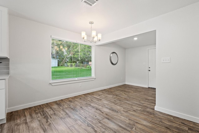 1005 W Bullock St, Denison, TX 75020 - unfurnished dining area featuring a chandelier, wood finished floors, and baseboards