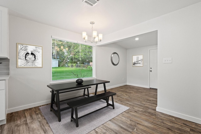 1005 W Bullock St, Denison, TX 75020 - dining room featuring a chandelier, dark wood-style flooring, and baseboards