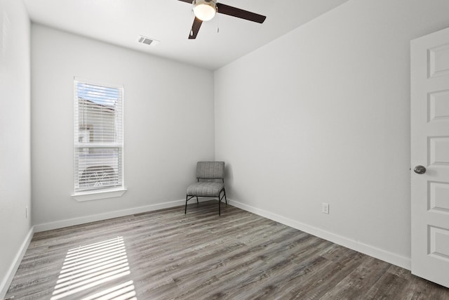 1005 W Bullock St, Denison, TX 75020 - empty room with a ceiling fan, wood finished floors, and baseboards
