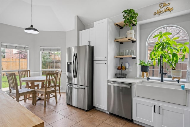 405 High Desert Dr, Fort Worth, TX 76131 - kitchen with appliances with stainless steel finishes, open shelves, light countertops, white cabinetry, and pendant lighting