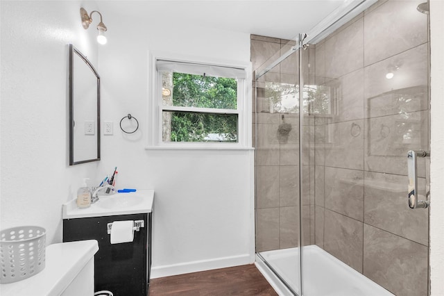 312 Dean St, Athens, TX 75751 - full bath with vanity, a stall shower, wood finished floors, and baseboards