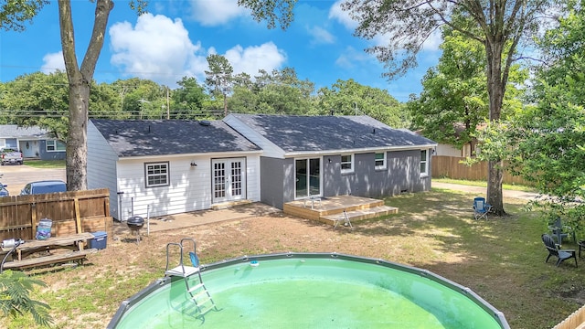 312 Dean St, Athens, TX 75751 - rear view of house featuring french doors, a deck, and roof with shingles