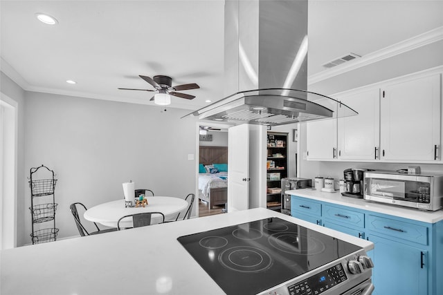 312 Dean St, Athens, TX 75751 - kitchen with appliances with stainless steel finishes, island exhaust hood, blue cabinetry, a ceiling fan, and crown molding