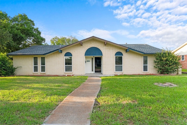 2325 Monticello Dr, Mesquite, TX 75149 - view of front of home featuring brick siding, a front lawn, and roof with shingles