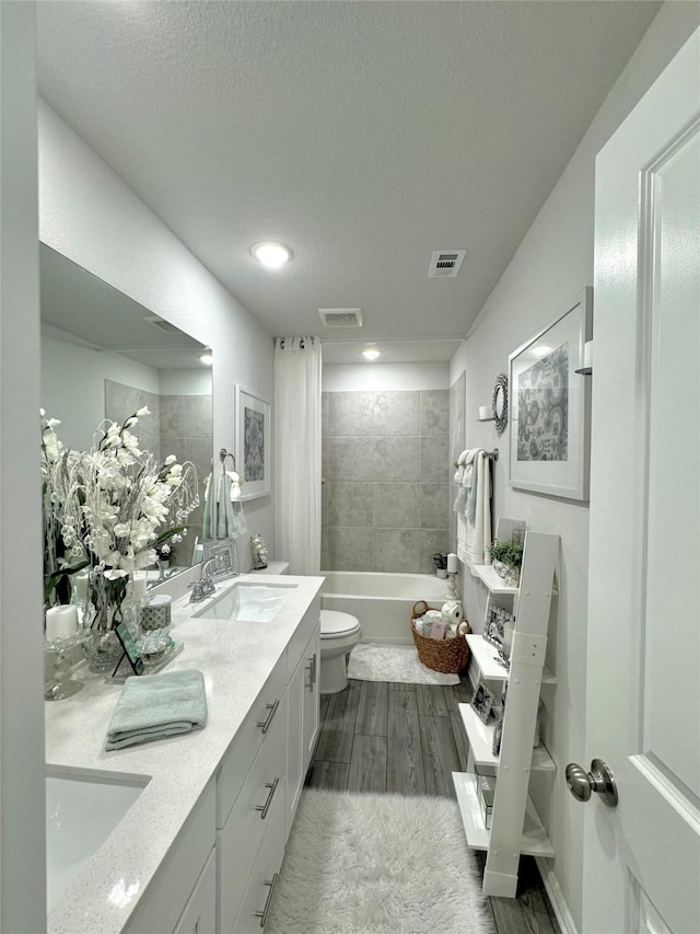 608 N Rain Barrel Pl, Weston, TX 75009 - full bathroom with toilet, double vanity, wood finished floors, shower / tub combination, and a textured ceiling