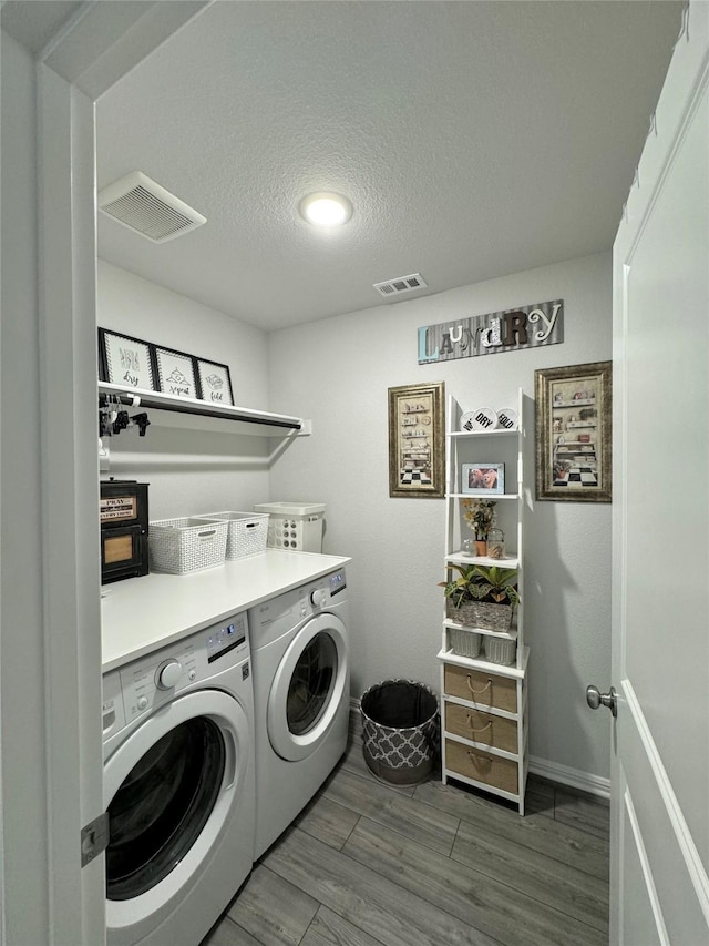 608 N Rain Barrel Pl, Weston, TX 75009 - laundry area with washing machine and dryer, a textured ceiling, wood finished floors, and baseboards