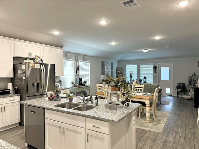 608 N Rain Barrel Pl, Weston, TX 75009 - kitchen featuring appliances with stainless steel finishes, a sink, a kitchen island with sink, white cabinets, and wood finished floors