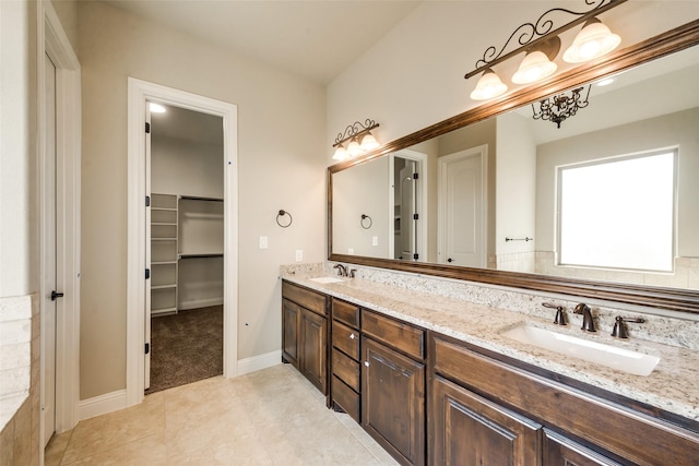 3201 Windcrest Dr, Granbury, TX 76049 - full bathroom featuring double vanity, tile patterned floors, a spacious closet, and baseboards