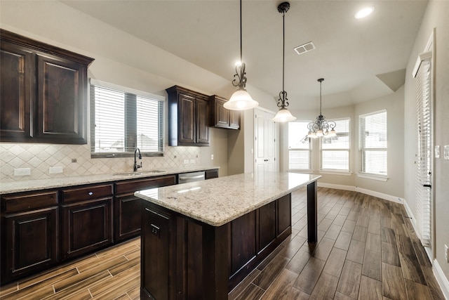 3201 Windcrest Dr, Granbury, TX 76049 - kitchen featuring a sink, wood tiled floors, backsplash, baseboards, and stainless steel dishwasher