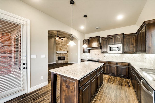 3201 Windcrest Dr, Granbury, TX 76049 - kitchen featuring a ceiling fan, custom exhaust hood, appliances with stainless steel finishes, wood finish floors, and dark brown cabinetry