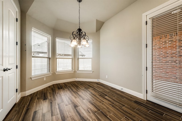 3201 Windcrest Dr, Granbury, TX 76049 - unfurnished dining area featuring a chandelier, dark wood-style floors, baseboards, and vaulted ceiling