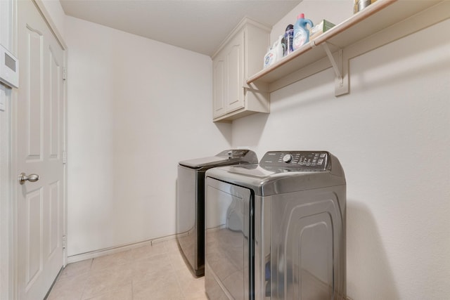 1322 Turnbridge Dr, Glenn Heights, TX 75154 - laundry area featuring washing machine and dryer, cabinet space, light tile patterned floors, and baseboards