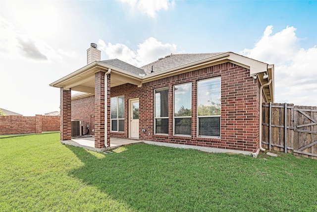 1322 Turnbridge Dr, Glenn Heights, TX 75154 - rear view of house with brick siding, central air condition unit, a chimney, and a patio