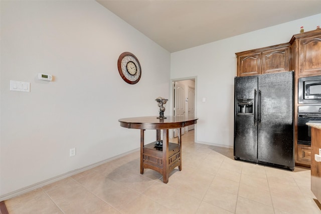 1322 Turnbridge Dr, Glenn Heights, TX 75154 - kitchen with black appliances, light tile patterned flooring, baseboards, light countertops, and lofted ceiling