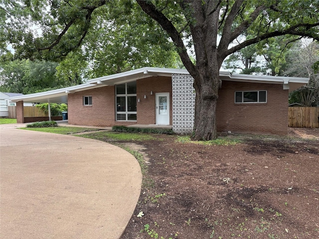 104 W Cayuga Dr, Athens, TX 75751 - view of front facade featuring brick siding, an attached carport, and driveway