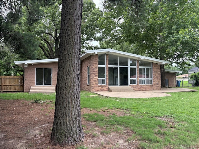 104 W Cayuga Dr, Athens, TX 75751 - rear view of property featuring a patio, entry steps, brick siding, and a sunroom