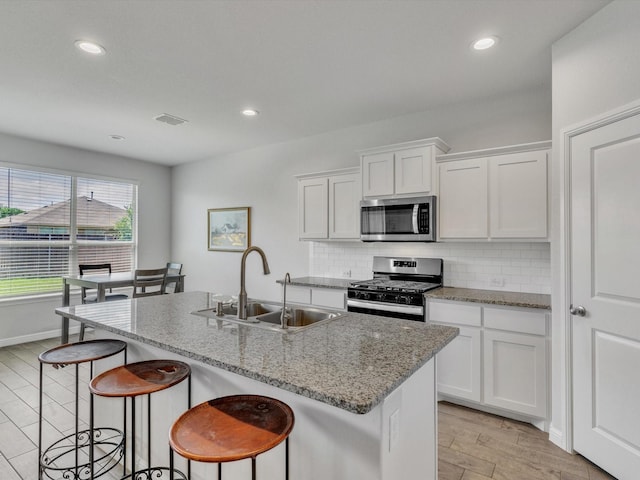133 Hollytree Ln, Boyd, TX 76023 - kitchen with appliances with stainless steel finishes, a sink, decorative backsplash, white cabinets, and recessed lighting