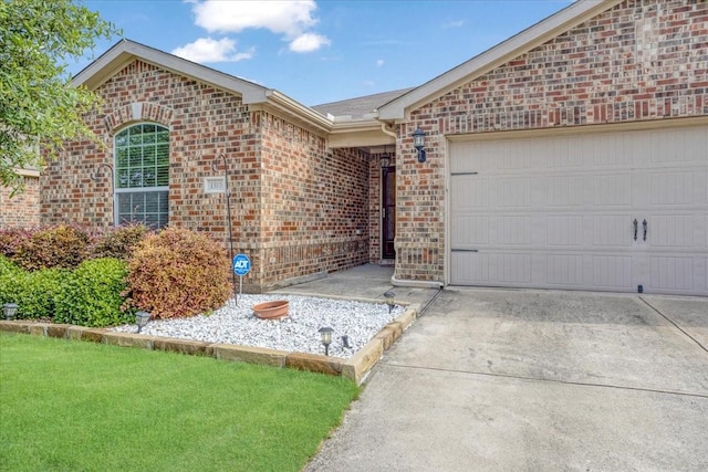 1310 Shumard Dr, Princeton, TX 75407 - ranch-style home featuring brick siding, concrete driveway, and an attached garage