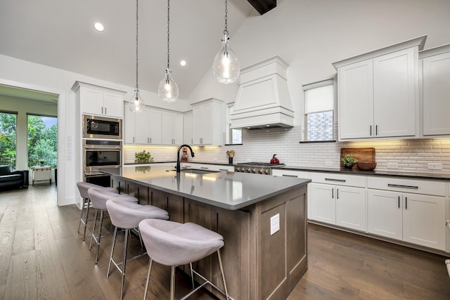 13445 Meadow Cross Dr, Fort Worth, TX 76008 - kitchen with stainless steel appliances, custom exhaust hood, a breakfast bar, an island with sink, and dark wood-style floors