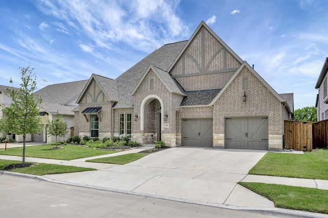 13445 Meadow Cross Dr, Fort Worth, TX 76008 - tudor house with brick siding, a shingled roof, concrete driveway, a garage, and stone siding