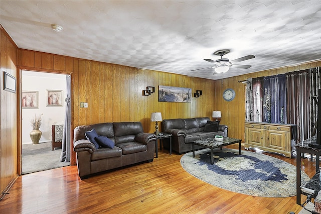 2825 Warren Ave, Dallas, TX 75215 - living area with wood walls, ceiling fan, and wood finished floors