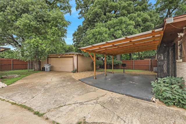 2825 Warren Ave, Dallas, TX 75215 - view of patio / terrace featuring an outdoor structure, a detached garage, and a carport