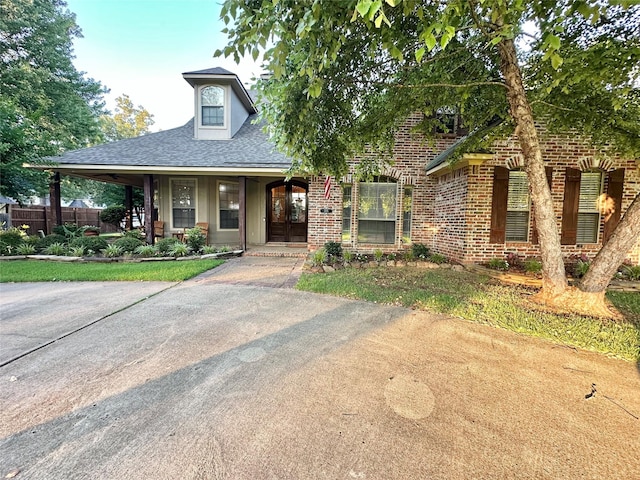 205 Old Palmetto Rd, Benton, LA 71006 - view of front of home with roof with shingles, brick siding, and covered porch