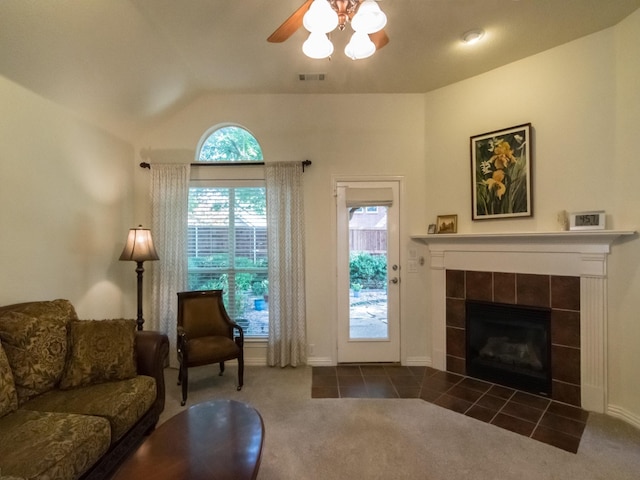 8205 Rayburn Ln, Mckinney, TX 75072 - carpeted living area featuring ceiling fan, a fireplace, vaulted ceiling, and baseboards