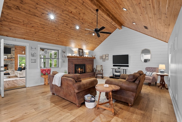 828 Crooked Creek Rd, Edgewood, TX 75117 - living area with a fireplace, wooden ceiling, ceiling fan, light wood-type flooring, and wooden walls