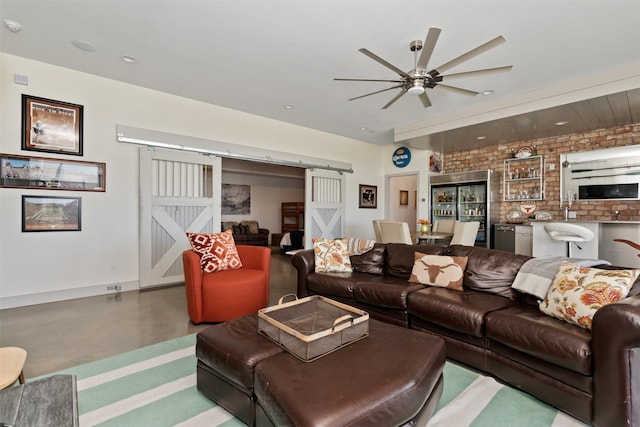 13390 Waterside Dr, Malakoff, TX 75148 - living area with a barn door, concrete flooring, a ceiling fan, baseboards, and recessed lighting