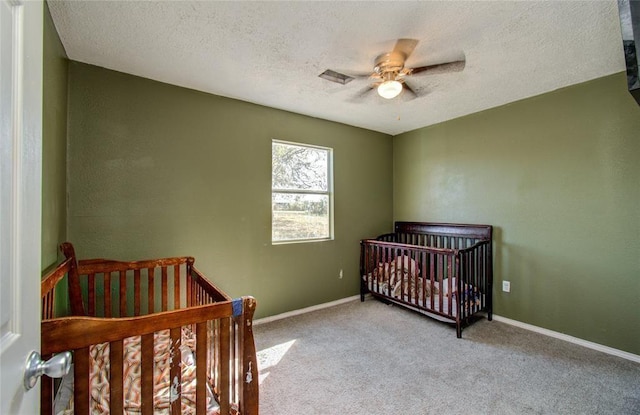 23899 Sagewood Ln, Bedias, TX 77831 - carpeted bedroom featuring a textured ceiling, ceiling fan, and baseboards