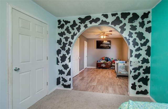 23899 Sagewood Ln, Bedias, TX 77831 - carpeted entryway featuring arched walkways, baseboards, and ceiling fan