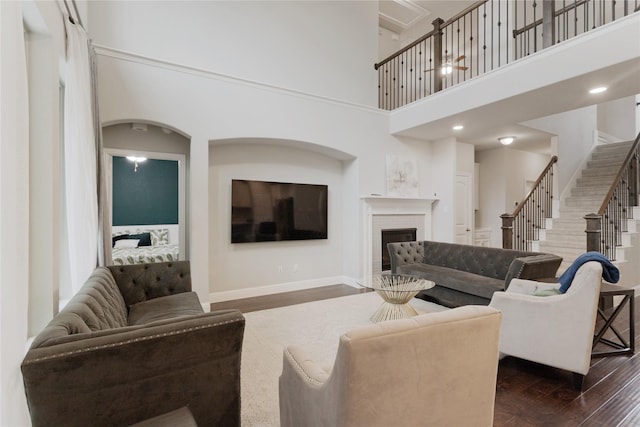 11408 Morrow Ln, Mckinney, TX 75071 - living area featuring a high ceiling, dark wood finished floors, a fireplace, and stairs
