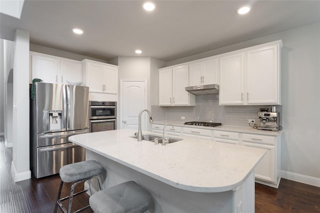 11408 Morrow Ln, Mckinney, TX 75071 - kitchen with appliances with stainless steel finishes, dark wood-type flooring, white cabinets, tasteful backsplash, and recessed lighting