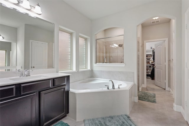 11408 Morrow Ln, Mckinney, TX 75071 - bathroom with a garden tub, vanity, a walk in closet, tile patterned flooring, and a shower