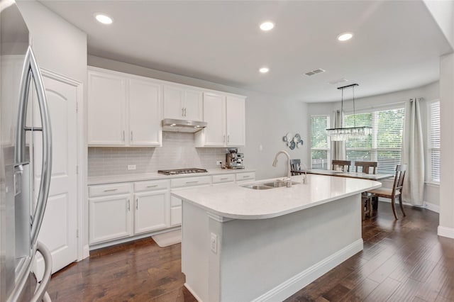 11408 Morrow Ln, Mckinney, TX 75071 - kitchen featuring appliances with stainless steel finishes, under cabinet range hood, light countertops, backsplash, and dark wood finished floors