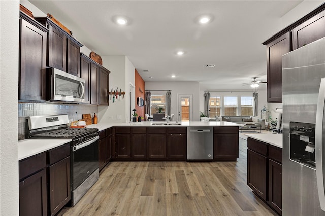 126 Condor Pass, Caddo Mills, TX 75135 - kitchen featuring stainless steel appliances, open floor plan, a peninsula, light countertops, and recessed lighting