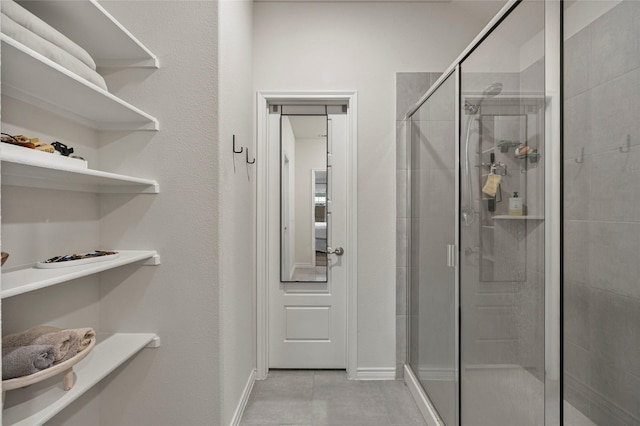 126 Condor Pass, Caddo Mills, TX 75135 - bathroom featuring a shower stall, tile patterned flooring, and baseboards
