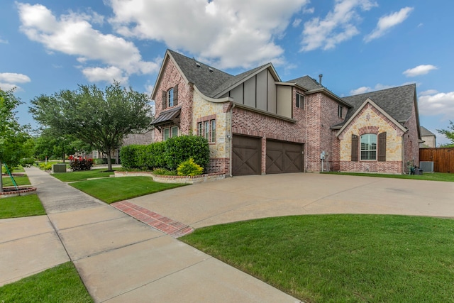 7132 Jernigan Dr, Frisco, TX 75034 - view of front of home with a garage, brick siding, driveway, a shingled roof, and board and batten siding