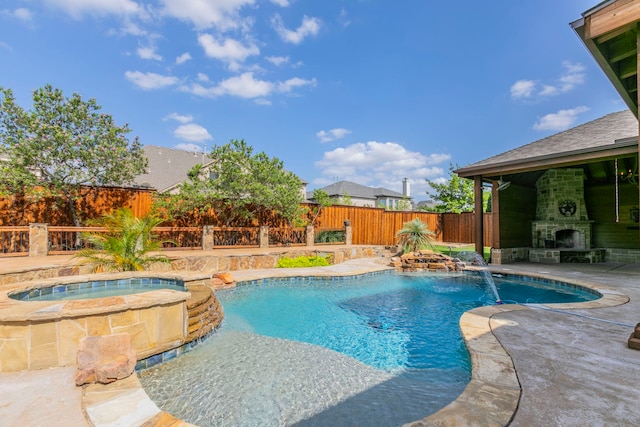 7132 Jernigan Dr, Frisco, TX 75034 - view of pool featuring an outdoor stone fireplace, a fenced backyard, a patio, and a pool with connected hot tub