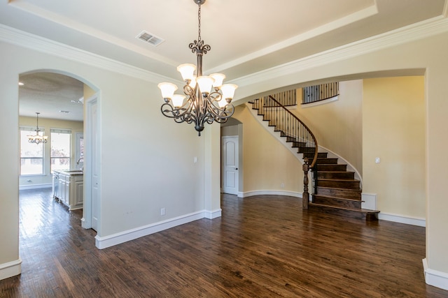 7132 Jernigan Dr, Frisco, TX 75034 - unfurnished room with a chandelier, arched walkways, dark wood finished floors, stairs, and ornamental molding