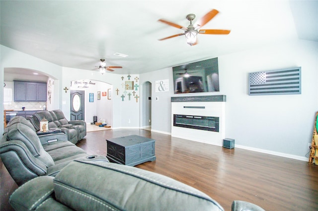 131 Live Oak Ln, Decatur, TX 76234 - living area with a ceiling fan, arched walkways, dark wood finished floors, and baseboards