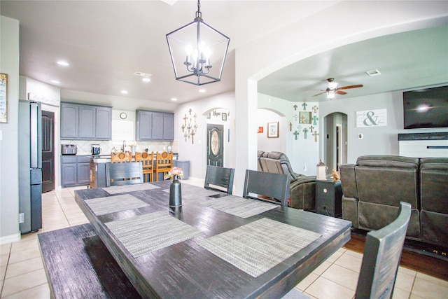 131 Live Oak Ln, Decatur, TX 76234 - dining area featuring arched walkways, light tile patterned floors, a ceiling fan, a chandelier, and recessed lighting