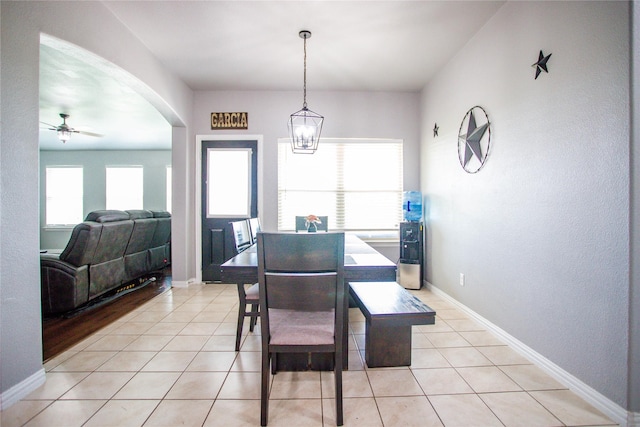 131 Live Oak Ln, Decatur, TX 76234 - dining room with light tile patterned flooring, arched walkways, ceiling fan, and baseboards