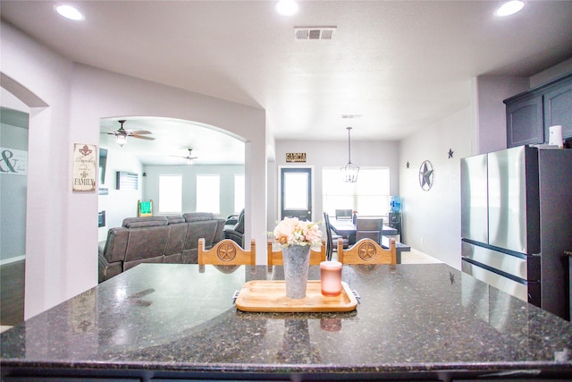 131 Live Oak Ln, Decatur, TX 76234 - kitchen featuring freestanding refrigerator, ceiling fan, arched walkways, a spacious island, and recessed lighting