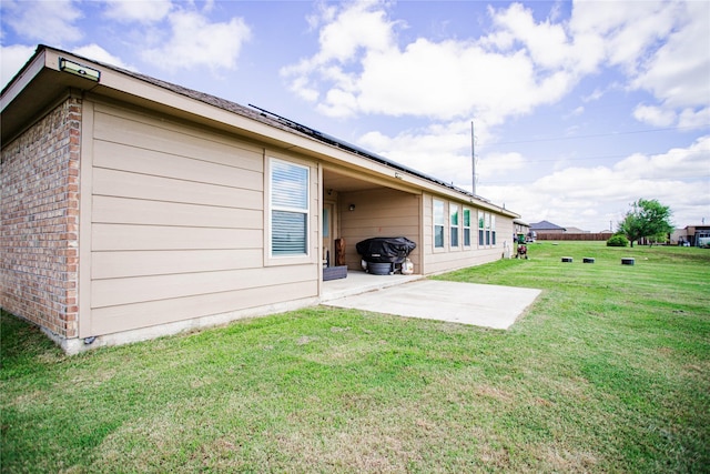 131 Live Oak Ln, Decatur, TX 76234 - back of property with brick siding, a patio area, and a yard