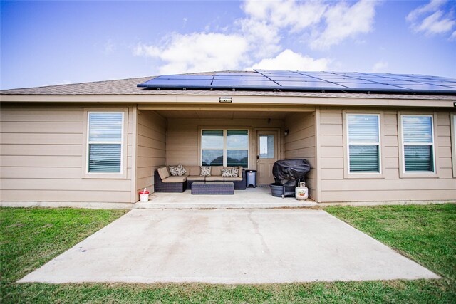 131 Live Oak Ln, Decatur, TX 76234 - back of house with outdoor lounge area, a patio, solar panels, and a yard