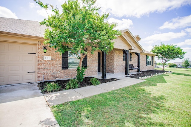 131 Live Oak Ln, Decatur, TX 76234 - single story home featuring brick siding, a front yard, concrete driveway, and a garage