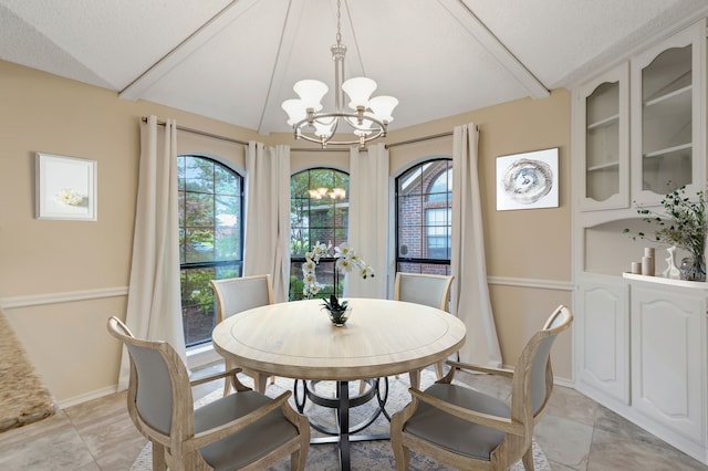 2049 Liverpool Dr, Plano, TX 75025 - dining room with a chandelier, lofted ceiling, a textured ceiling, and baseboards